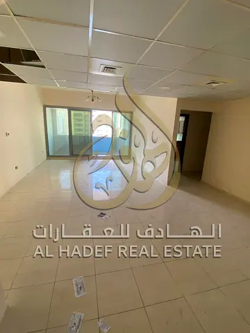 Two-bedroom apartment with a living room for rent in Al Majaz 2, with a spacious area, large balcony, air conditioning, and free parking.