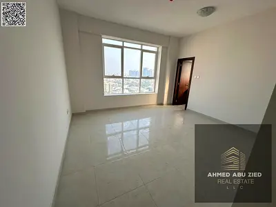 2BR hall apartment with private parking, first tenant at Corniche, Ajman. 2 masters, 3 baths, AC, balcony, sea view, built-in wardrobes, easy Dubai ex