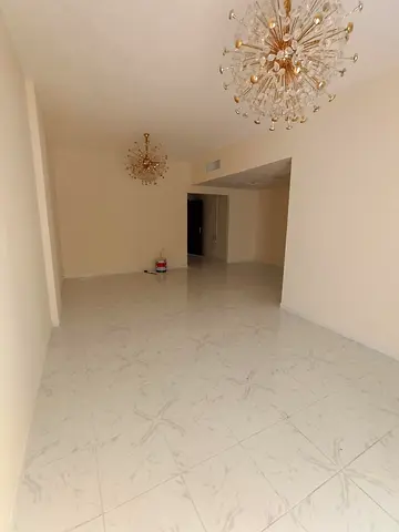 For rent in Al Majaz 3: 2BR + hall, 2 bathrooms, balcony, built-in wardrobes, central AC, prime main road location near the Corniche & services. 🌊🏡