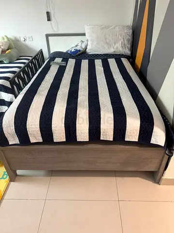 Single Bed with Modern Striped Quilt