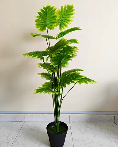Artificial tropical plant, similar to a monstera or palm bush