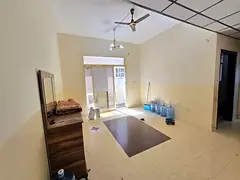 **1BR + hall for annual rent in Al Jurf 2, behind Delta Center, balcony, 2 baths, central AC, 27K AE