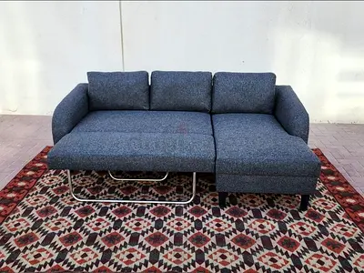 Grey Fabric L-Shape Sofa Bed. Comfortable seating and practical storage space.