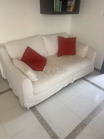 Comfortable White Sofa with Red Cushions