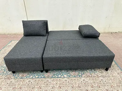L-Shape Grey Sofa Bed in good condition. Stylish look, space saving design, and hidden storage box.