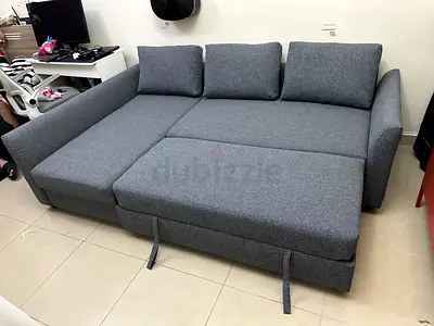 Elegant Grey Sofa Bed with chaise lounge. Converts into a bed easily and has extra storage for blank