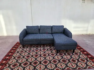Space-saving Grey Sofa Bed with chaise. Easily converts into a bed with extra storage.