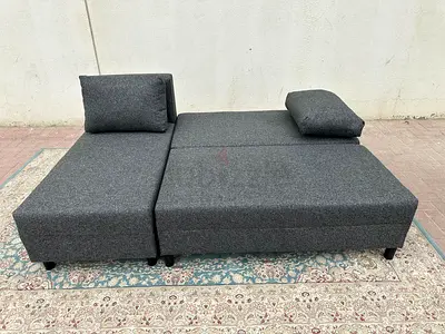 Comfortable Grey Fabric Sofa Bed with storage. Ideal for living room and guest use. Easy to open and