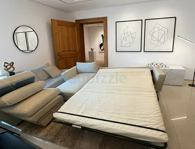 Elegant Beige Sofa Bed with pull-out bed system. Comfortable seating and spacious sleeping area.