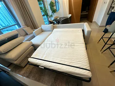 Beautiful cream sofa bed with soft cushions and strong metal bed frame.