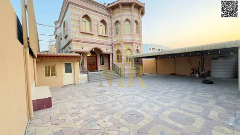 A stunning villa for sale in Ajman, Al Rawda 2 area, near Shurooq Mall, at a special price including electricity, water, air conditioning, and furnish