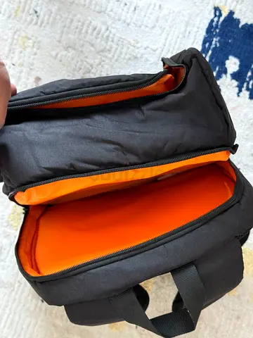 Stylish Black Backpack with Bright Orange Interior