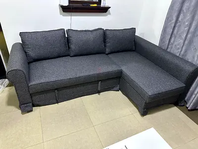 Luxury gray sofa bed, hidden storage compartment, soft foam cushions and sturdy wooden frame.