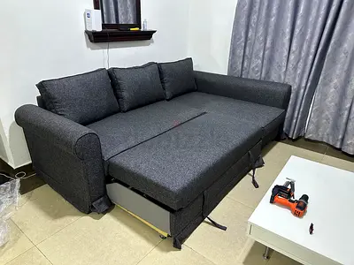 Luxury gray sofa bed, hidden storage compartment, soft foam cushions and sturdy wooden frame.