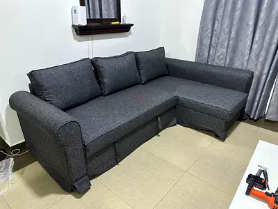 Beautiful gray sofa bed, easy fold-out bed system with storage for blankets and pillows.