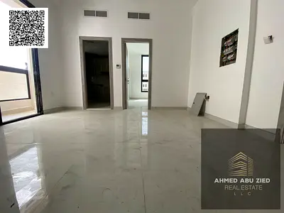 One-bedroom apartment for annual rent in Al Alia area, Ajman. Features include a master bedroom, two bathrooms, a balcony, built-in wardrobes, high-en