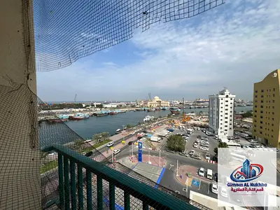 The most beautiful one-bedroom apartment with a living room in Al Jubail – first row on the corniche, featuring a balcony with an exceptional sea view