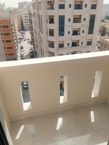 Spacious 1-bedroom apartment with balcony and open view on a main road in Al Qulaya’ah, Sharjah, close to all services.