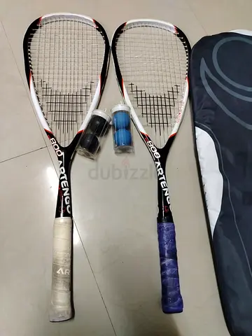 Artengo squash rackets along with their covers and accessory balls.