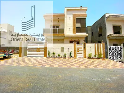 Villa for sale in Al Zahia area (Ajman) including water and electricity, 5 master bedrooms with a majlis, hall, equipped kitchen + maid's room. The vi