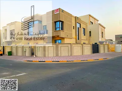 Corner villa for sale on two streets in Ajman, Al Zahia area. The villa consists of 5 master bedrooms, a majlis, a hall, and a maid's room. Freehold f