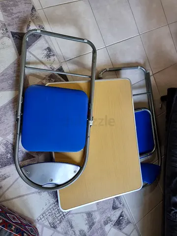 Two blue foldable chairs and table