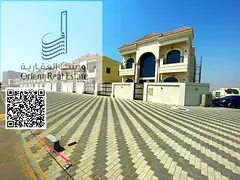 Villa for sale in Ajman, Al Helio 2 area, consisting of 5 master bedrooms with a majlis, a hall, and
