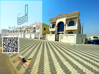 Villa for sale in Ajman, Al Helio 2 area, consisting of 5 master bedrooms with a majlis, a hall, and a maid’s room + a private indoor swimming pool +