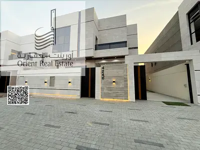 Villa for sale in Ajman, Al Helio 2 area, including registration and ownership fees, consisting of 4 master bedrooms with a majlis, a hall, a maid's r