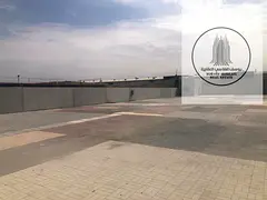 A unique investment opportunity for rent in Al Sajaa: a 20,000 sq ft plot of land with an interlocki