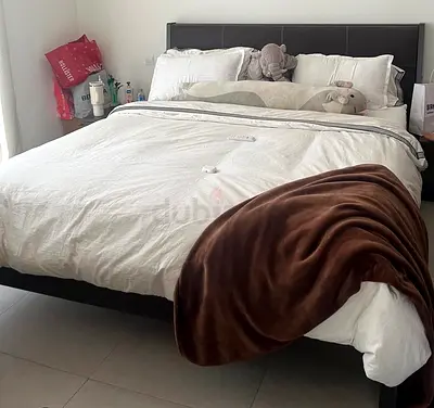 King size bed with leather headboard and two side tables