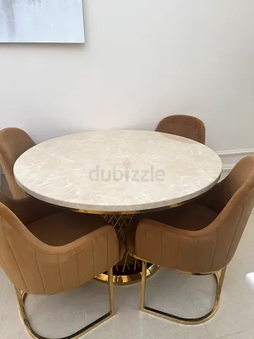 Elegant Round Dining Table with Plush Chairs