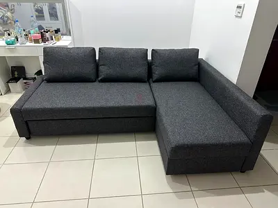 Space-Saving Sofa Bed with Storage Designed for modern apartments, this grey sofa easily converts in