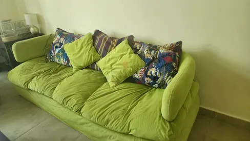 Comfortable Green Sofa with Colorful Cushions