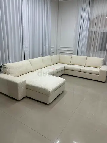 U-shaped corner sofa with elegant cream color, sleek lines, and a contemporary look to enhance any