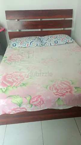 Wooden Bed Frame with Floral Bedding