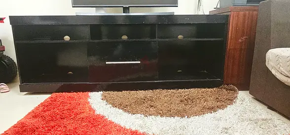 Stylish Black TV stand with wheels . Family moving urgently.