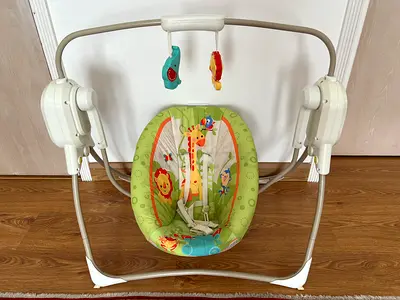 Fisher Price baby swing with music and relaxing noises. In perfect condition.