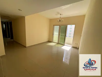 Balcony with open city view – Beautiful and elegant 2-bedroom apartment with a living room in Sharjah, featuring central AC and central gas .
