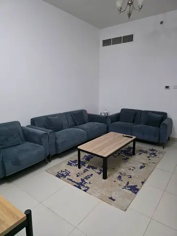 Modern L-Shaped Sofa with Coffee Table and Rug