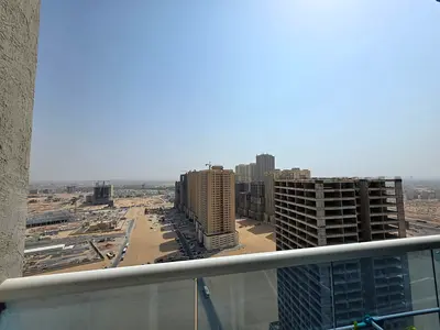 2-bedroom apartment in Golf Tower Ajman, high floor, free AC, balcony with open city view, ready to move in.