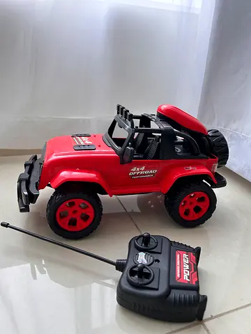 My red remote-control off-road truck with controller (used, working)