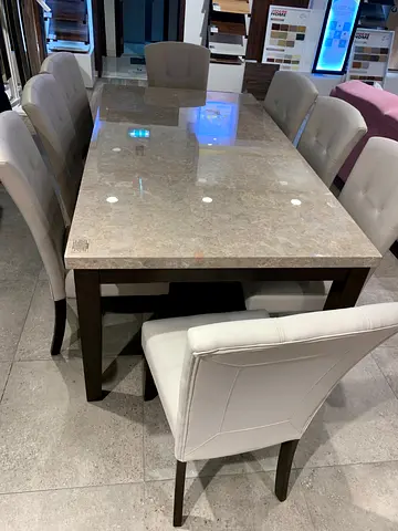 Marble-top dining table with 6 cream upholstered chairs