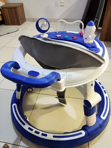 Gently used blue  white baby walker with toy tray and music.