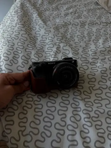 Sony Alpha A6400 with 16-50mm kit lens and leather case.