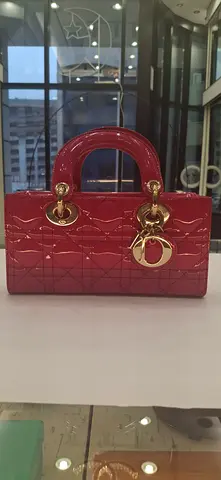 Red patent quilted top-handle handbag with gold charms
