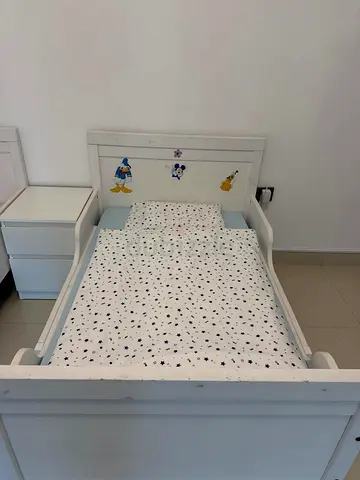 White wooden toddler bed with Disney stickers - good condition and can be adjust with adjust matress