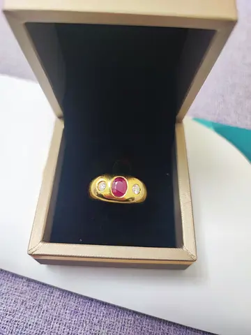 Gold ring with oval ruby 0.90ct and two natural diamond accents 0.50ct total