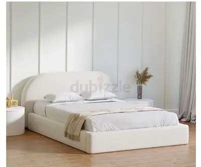 Cream boucle upholstered platform bed with rounded headboard