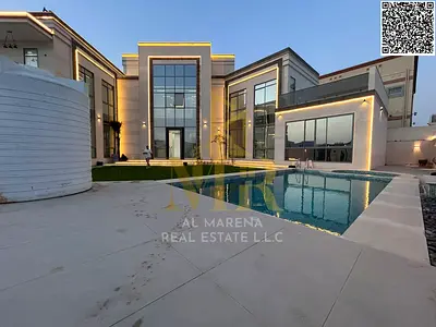 Luxury villa in Al Yasmin, featuring a majlis, master living room, and two rooftop floors, all on a spacious plot, with the price including electricit